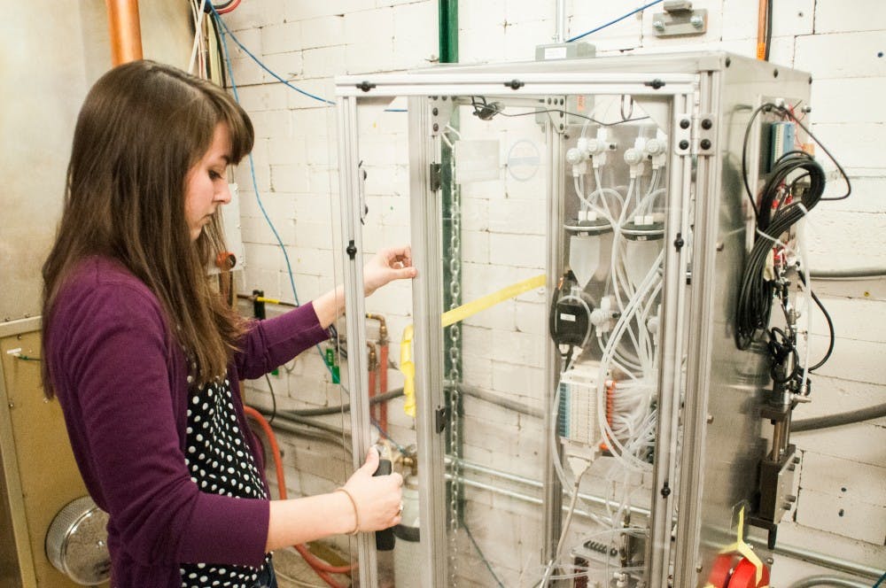 Graduate student Paige Abel explains processes of an automated water chamber on March 21, 2017 at Facility for Rare Isotope Beams. The facility produces radioactive beams that individuals can study; there are about 800 people who work and do research at the facility. 