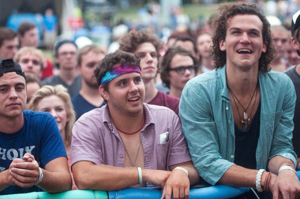 From left to right, Toledo, Ohio residents Connor Lake, Mitch Layman, and Bailey Crawford cheer on Dr. Dog during Common Ground Music Festival on July 12, 2014, at Adado Riverfront Park in downtown Lansing. The trio came from Ohio to come to Common Ground. 