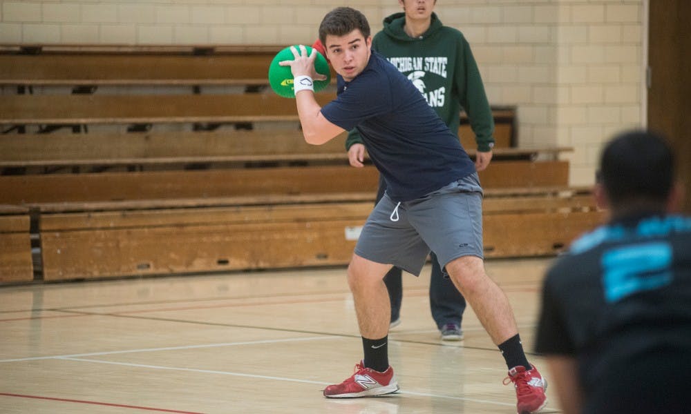 <p>Electrical engineering freshman Sandros Rivera prepares to throw the ball during dodgeball practice on Nov. 5, 2015 at IM Sports-Circle.  Rivera says that for him, dodgeball is a great way to keep active and utilize his skills from playing baseball. </p>