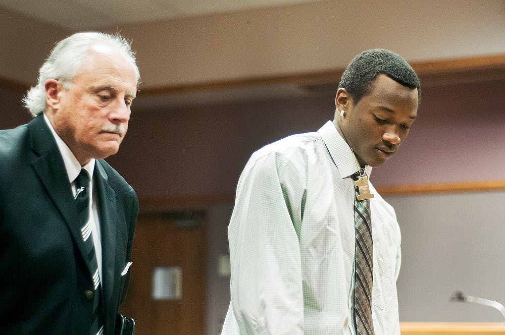 	<p>Redshirt freshman cornerback Ezra Robinson, right, exits the courtroom with defense attorney James Heos, left, after his Sept. 16, 2013 sentencing at the East Lansing 54B District Court, 101 Linden Street. Robinson was arrested in July for an underage drinking and driving offense. Danyelle Morrow/The State News</p>