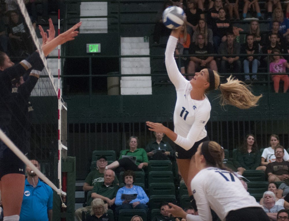 Senior outside hitter Chloe Reinig (11) spikes the volleyball during the volleyball game against Notre Dame on Sept. 16, 2016 at the Jenison Field House. The Spartans defeated the Fighting Irish, 3-0. 