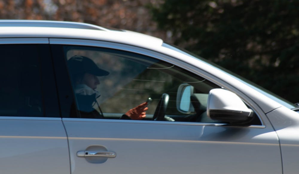 <p>Woman wearing protective gear waiting in line at Michigan State Univeristy&#x27;s COVID-19 drive-through testing site on April 2, 2020.</p>