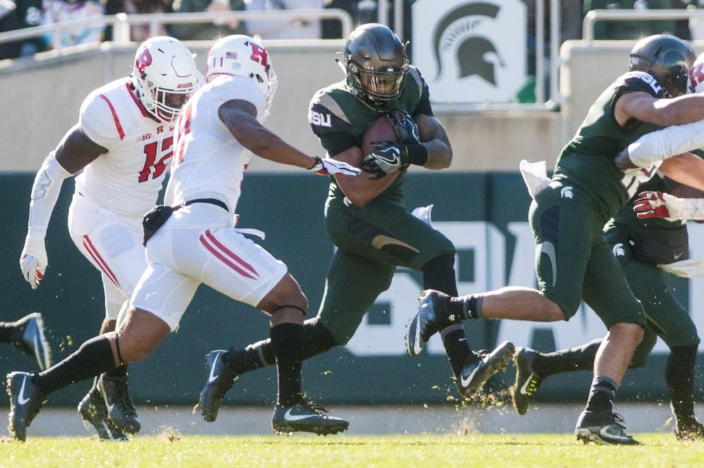 Junior running back Gerald Holmes (24) runs the football during the game against Rutgers on Nov. 12, 2016 at Spartan Stadium. The Spartans defeated the Scarlet Knights, 49-0.