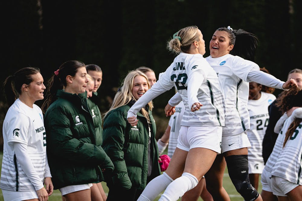 <p>MSU junior defender Ella Janz (22) chestbumps with her teammate at the DeMartin Soccer Stadium in East Lansing, MI, on Nov. 23, 2025.</p>