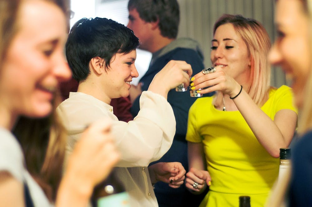 	<p>German junior Emily Robinson, left, celebrates her 21st birthday with her friend, psychology senior Sara Hockin on March 28, 2013, at a friend&#8217;s apartment. Robinson went out to the bars with her friends later that night. Julia Nagy/The State News</p>