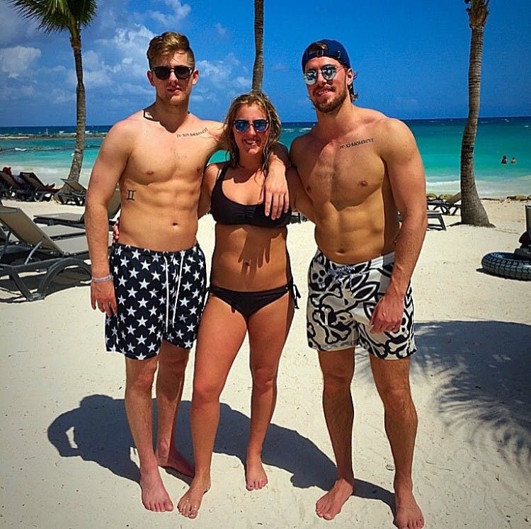 <p>Twins Cody Milan (left) and Devin (middle) with their brother Daniel (right) pose for a picture. Photo courtesy of Milan family.</p>