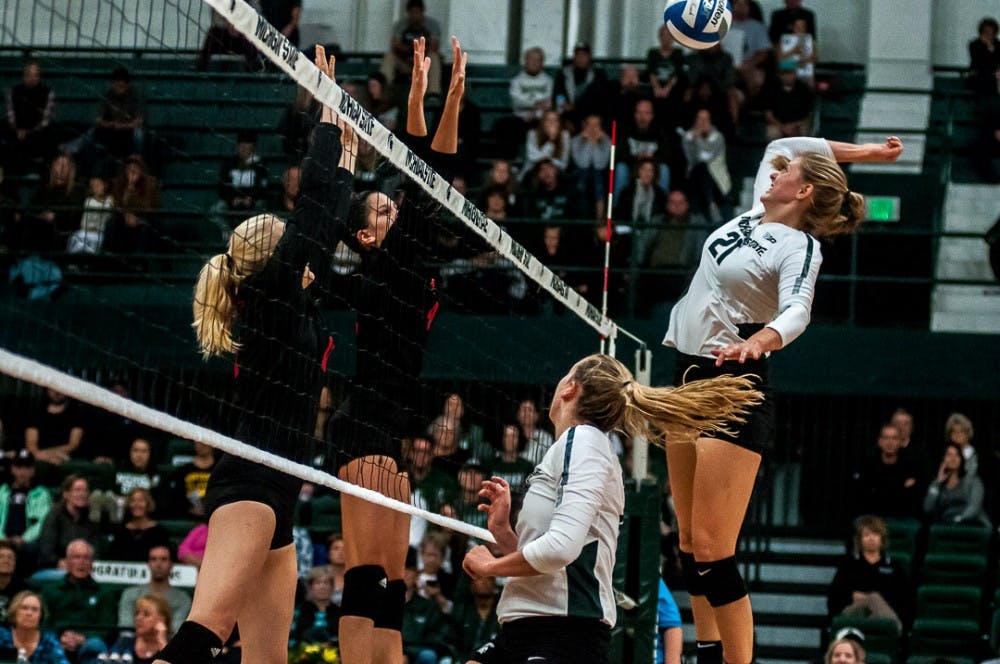 Freshman middle blocker Rebecka Poljan (21) hits the ball during the game against Rutgers on Sept. 29, 2018 at Jension Fieldhouse. The Spartans  the Scarlet Knights   .