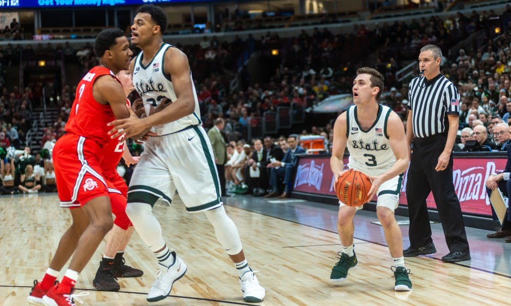 <p>Freshman guard Foster Loyer (3) shoots a three-pointer against Ohio State. The Spartans beat the Buckeyes, 77-70 at the United Center on March 15, 2019.</p>