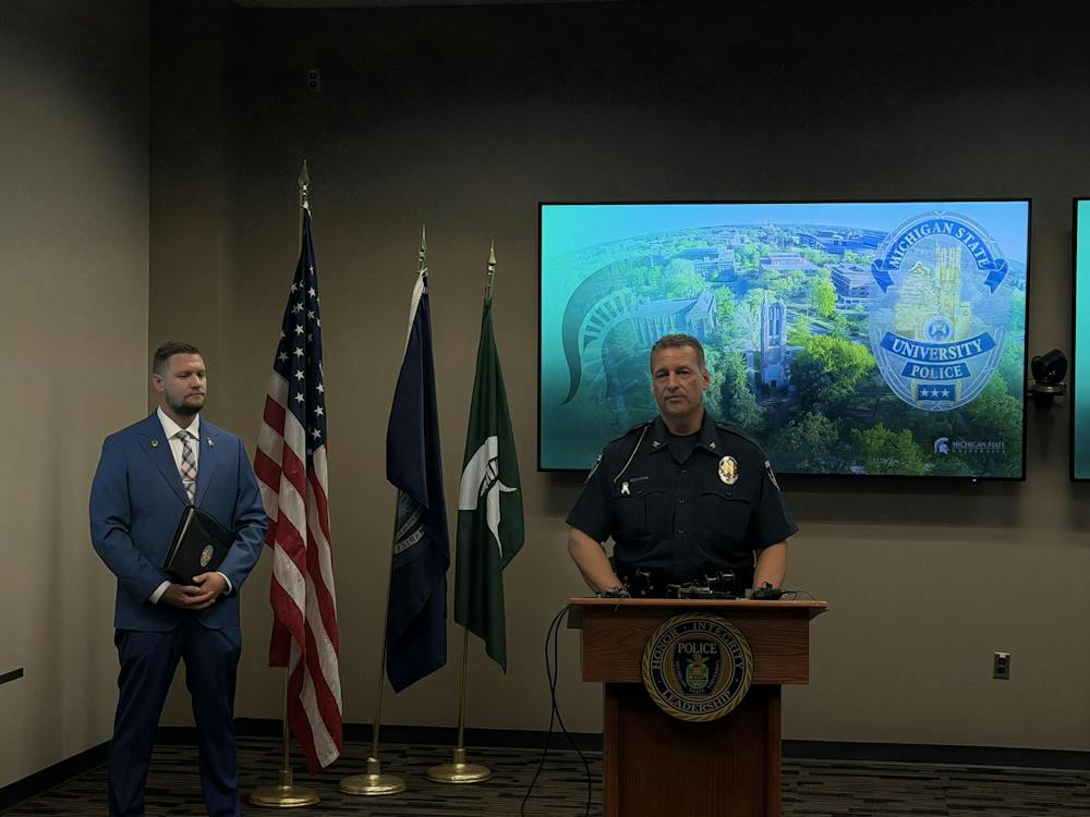 <p>Chief of Police and Executive Director of Public Safety at Michigan State University Mike Yankowski gives a speech with Detective Sergeant Aaron Schroeder standing on the left in East Lansing, Mich., on Friday, Sept. 11, 2026.</p>