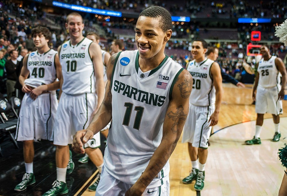 	<p>Junior guard Keith Appling walks off the court smiling at the conclusion of the third round of the <span class="caps">NCAA</span> Tournament game against Memphis. The Spartans defeated the Tigers, 70-48, Saturday, March 23, 2013, at The Palace of Auburn Hills in Auburn Hills, Mich. Justin Wan/The State News</p>