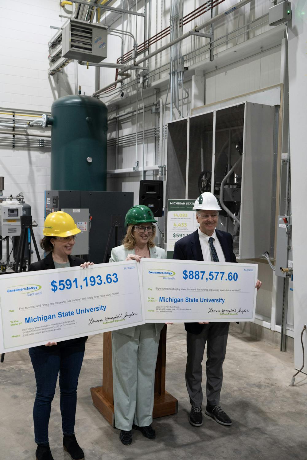 <p>Interim-President Teresa Woodruff holds an oversized check representing the MSU's energy rebates at the Simon Power Plant at a media event on March 20th, 2023.</p>
