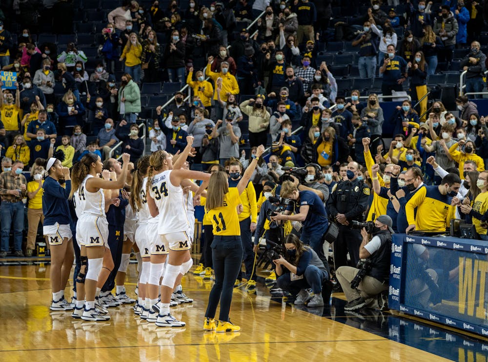 The Wolverines celebrate their 62-51 victory over their rivals, the Spartans, at the Crisler Center on Feb. 24, 22.