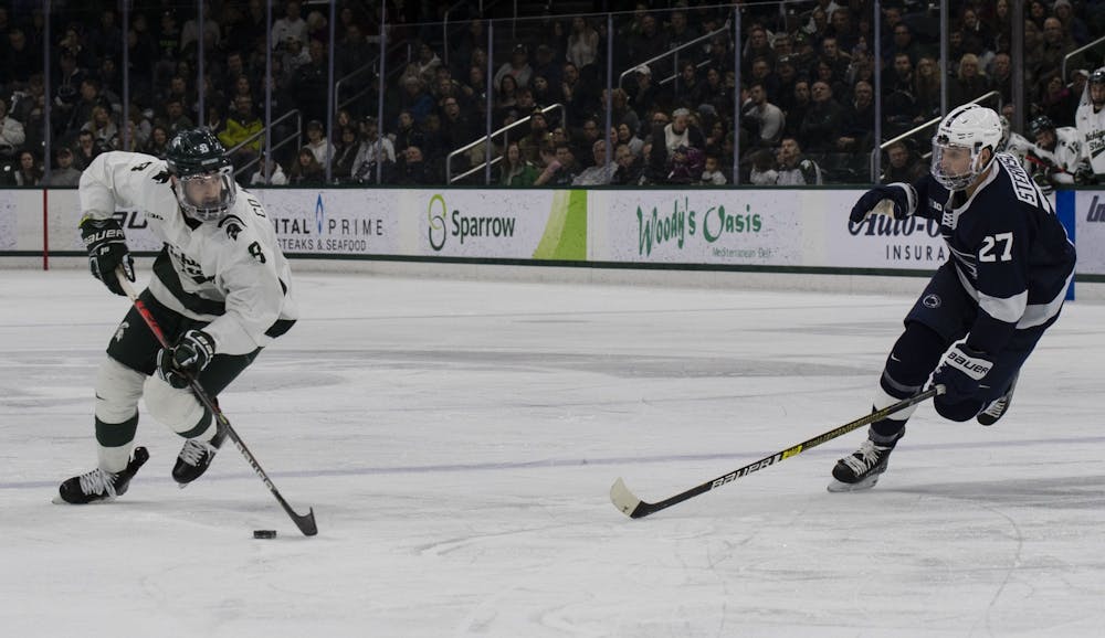 Sophomore right defense Cole Krygier (8) skates the puck down the ice toward the Penn State goal. Michigan State fell to Penn State 2-1 on January 25, 2020.