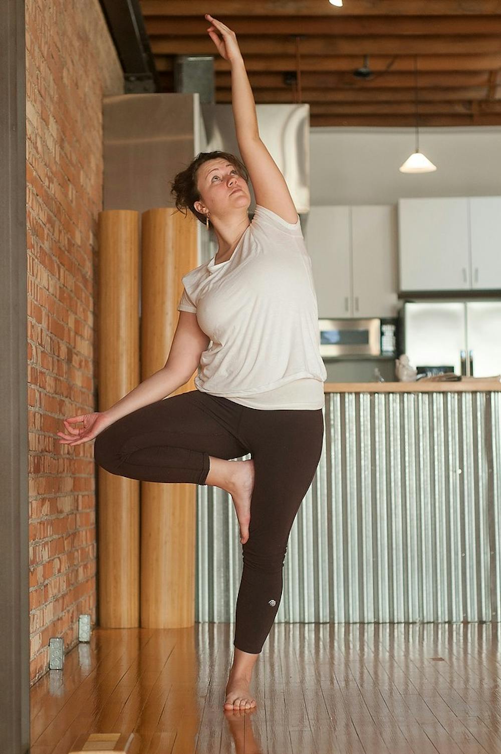 <p>Lansing resident and yoga instructor Bobbi Jo Minor demonstrates a pose Feb 28, 2015, at Hilltop Yoga 107 E Grand River Ave, Lansing. Kennedy Thatch/The State News </p>