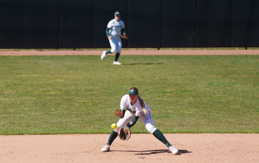 <p>Michigan State freshman Kayleigh Roper catching a ground ball and throwing it to first. Spartans lost 5-4 against Nebraska, on April 10, 2022.</p>