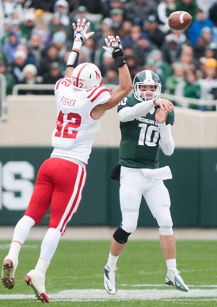 	<p>Junior quarterback Andrew Maxwell makes a pass around a Nebraska defender Nov. 3, 2012, at Spartan stadium. The final score was 28-24 with the Cornhuskers coming out on top. Katie Stiefel/ State News</p>
