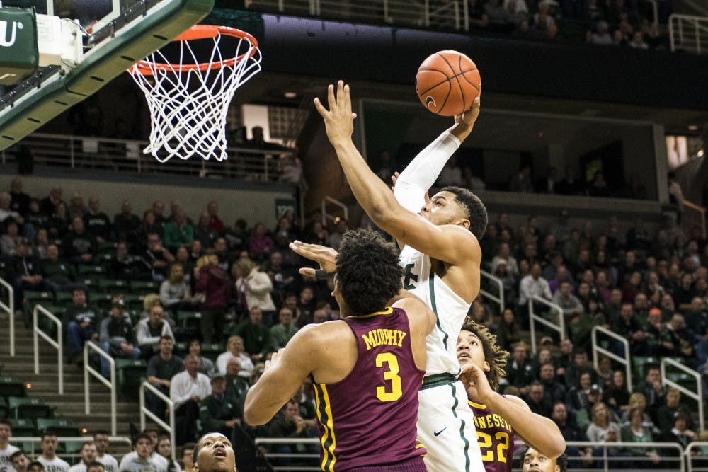 Freshman guard Miles Bridges (22) goes for a dunk during the first half of the men's basketball game against Minnesota on Jan. 11, 2017 at Breslin Center. 