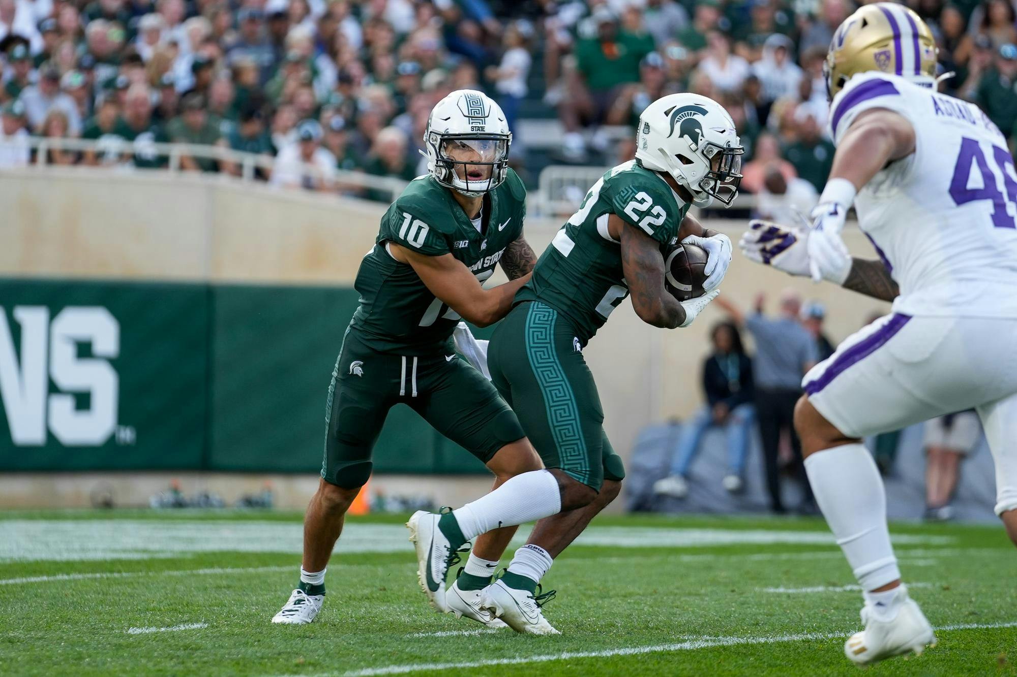 Redshirt junior quarterback Noah Kim (10) hands the ball off to senior running back Jordon Simmons (22) during a game against University of Washington at Spartan Stadium on Sept. 16, 2023.