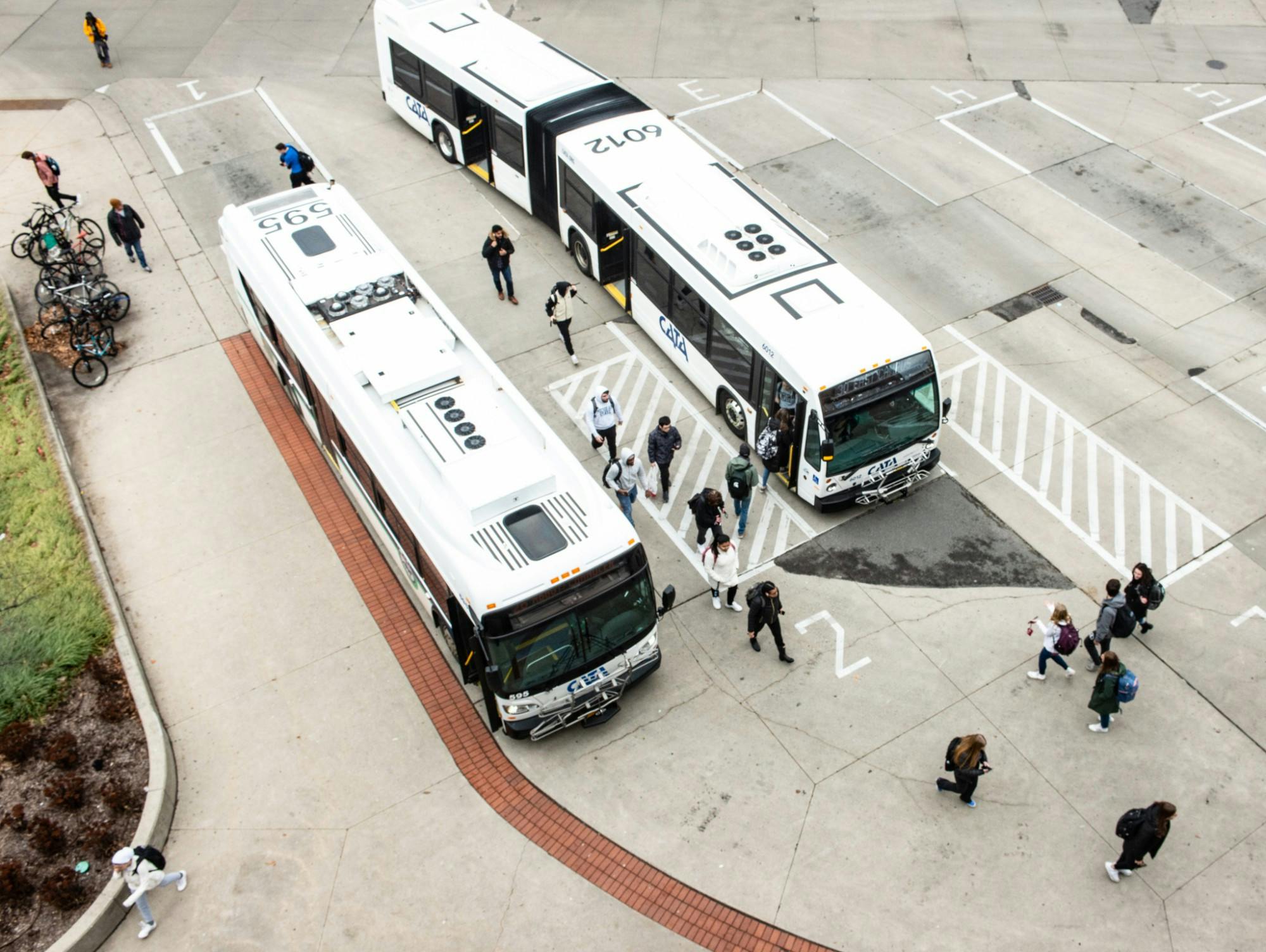 <p>Students get on and off CATA buses after MSU sent an email notifying students that administration canceled classes after noon on March 11, 2020.</p>