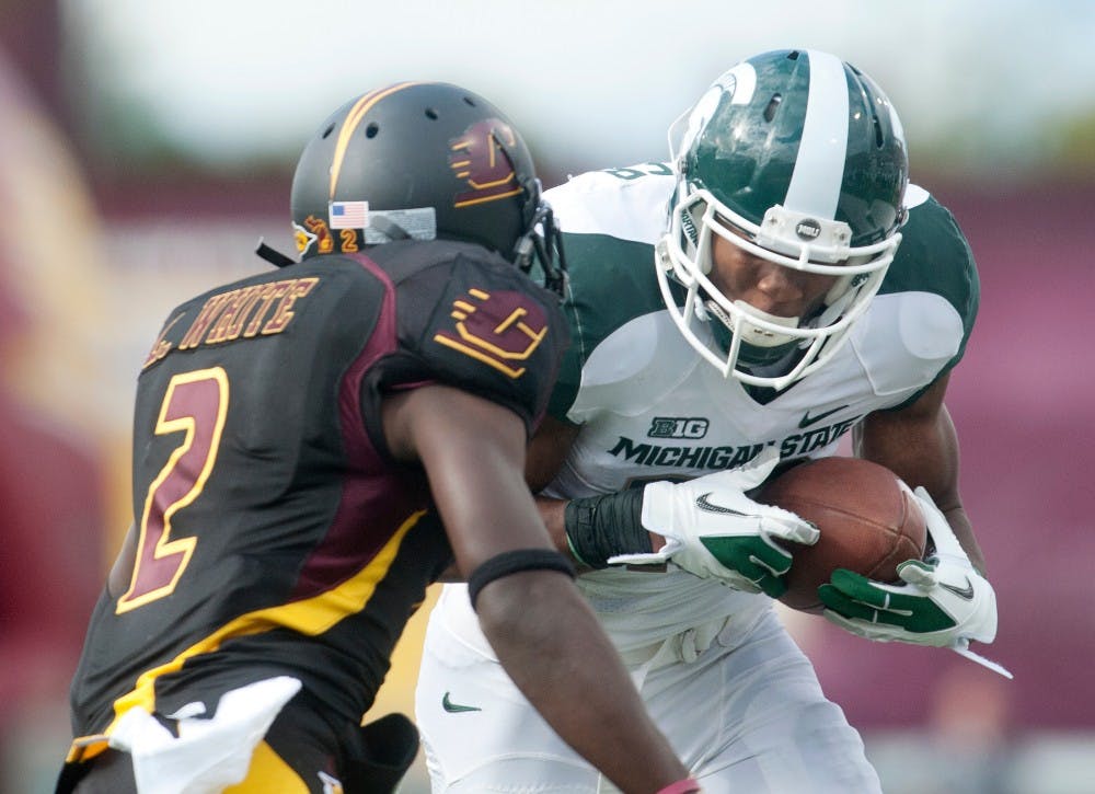 Junior wide receiver Bennie Fowler catches a long pass withCentral Michigan's defensive back Lorenzo White creates pressure from the side. The Spartans defeated the Chippewas, 41-7, on Saturday, Sept. 8, 2012, at Kelly/Shorts Stadium in Mount Pleasant, Mich. Justin Wan/The State News