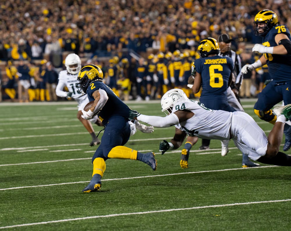 <p>Michigan State defensive tackle Dashaun Mallory (94) attempts to tackle Michigan's running back Blake Corum (2) during the Spartans' loss on Oct. 29, 2022</p>