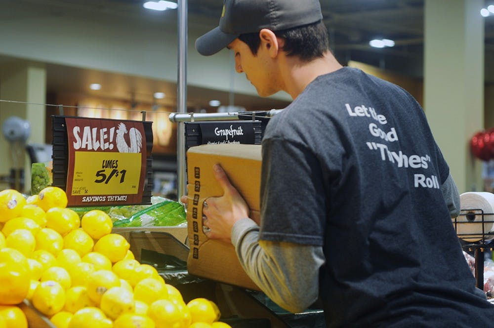 <p>Produce clerk Lukas Sundberg disperses lemons in the fruit aisle May 30, 2015, at the Fresh Thyme Farmers Market, 930 Trowbridge Road, in East Lansing. Asha Johnson/The State News. </p>