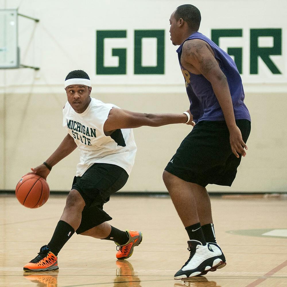 	<p>Construction management junior Ed Davis, right, defends television and film actor Pooch Hall during the Hoops for Hope charity basketball game, Sept. 28, 2013, at IM West. The <span class="caps">MSU</span> Greek All Star team played against a team of <span class="caps">MSU</span> basketball alumni and celebrities to raise money for Lansing families. Danyelle Morrow/The State News</p>