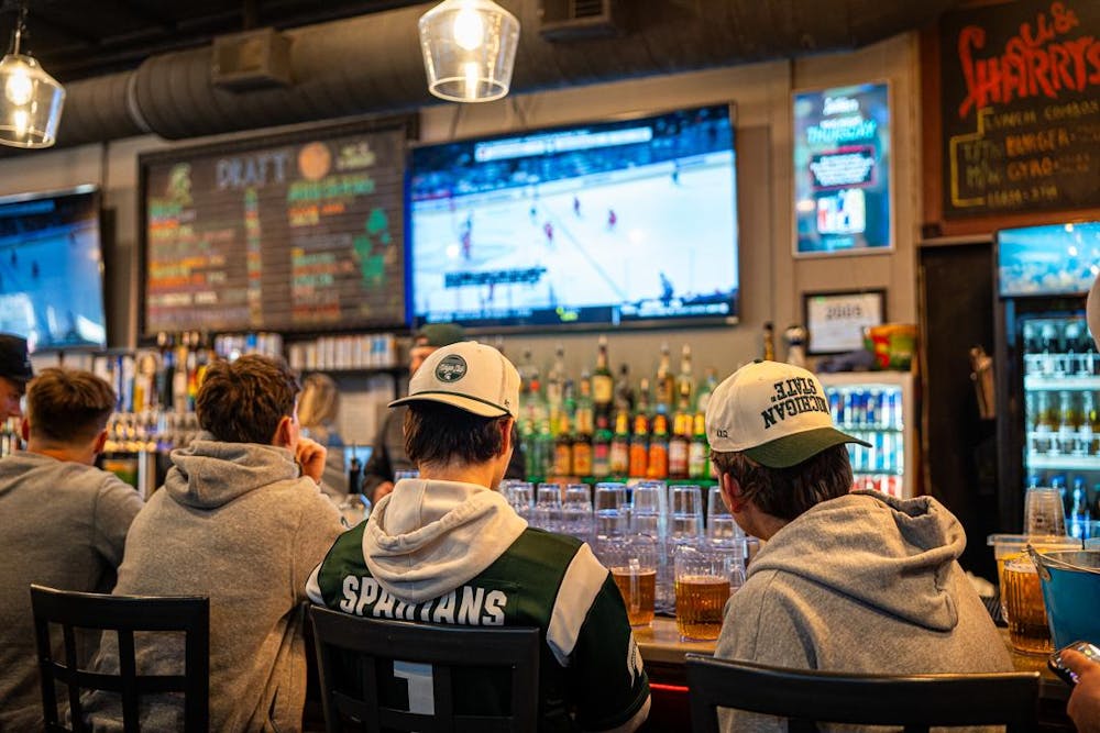 <p>MSU fans watch the Michigan State hockey team face off against the Wisconsin Badgers at Lou and Harry's Bar and Grill in East Lansing, MI on March 28, 2026. The Spartans fell to the Badgers in overtime, 4-3.</p>