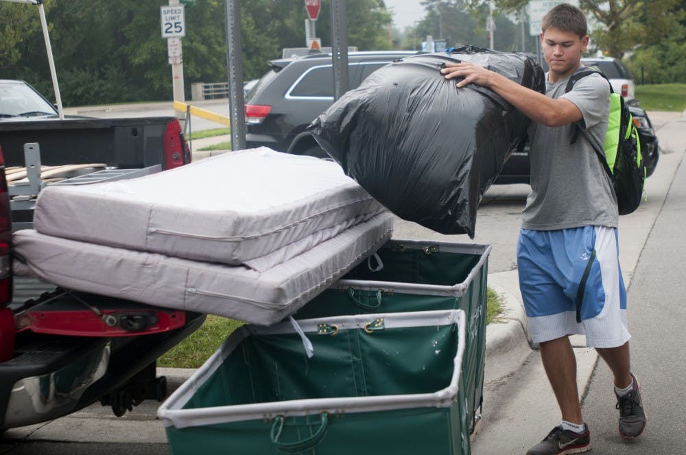 <p>Engineering freshman Cody Voelker begins to unpack his truck on Aug. 30, 2015, at Brody Complex. Courtney Kendler/The State News</p>