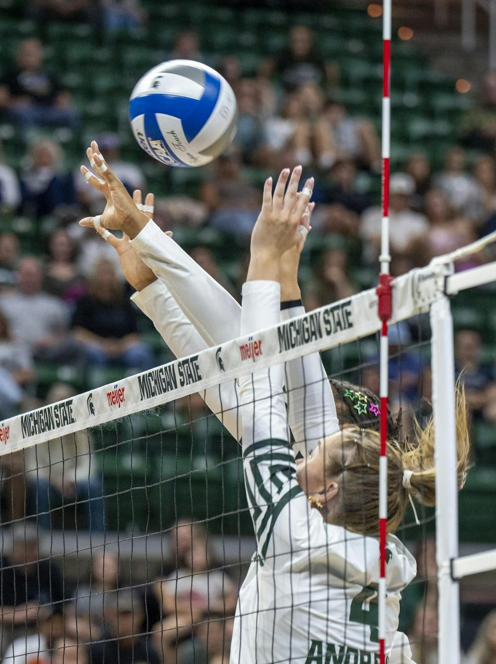 MSU Freshmen Madi Andrews #4 blocks spike with teamate at the Breslin Center during the MSU v Pennstate Volleyball game In East Lansing, MI on Sunday Sep. 27th, 2026
