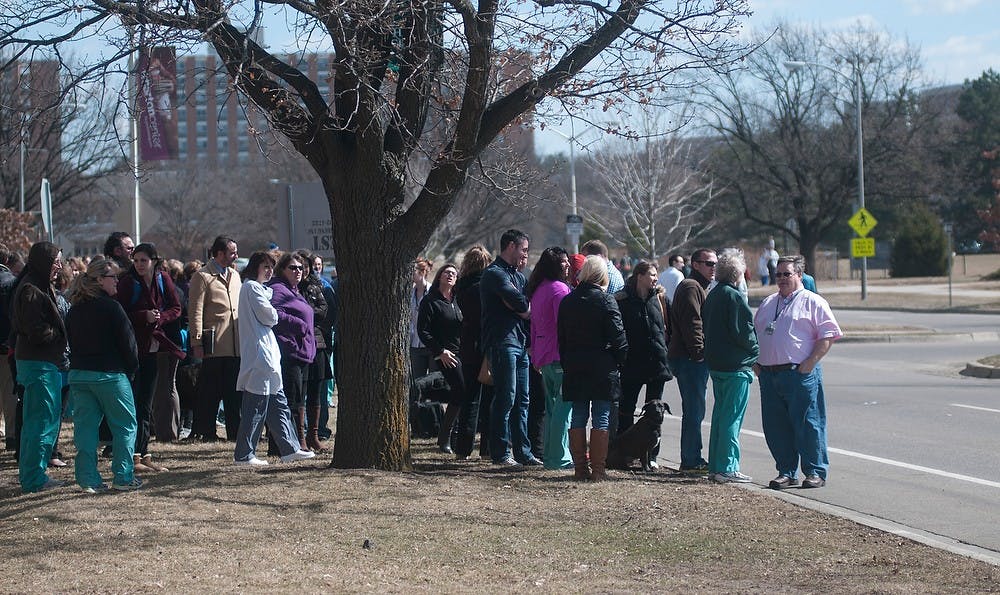 <p>Individuals await news after being evacuated Mar. 18, 2015 from the Veterinary Medicine Center on 736 Wilson Rd. A natural gas leak was confirmed.</p>