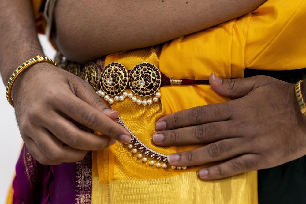 Anand adds a classical Indian wallet chain to his costume in a dressing room before his performance in the Sri Sharadamba Temple in Farmington Hills, Mich. “I love wearing those,” he said. “It adds so much to the aesthetic." 
