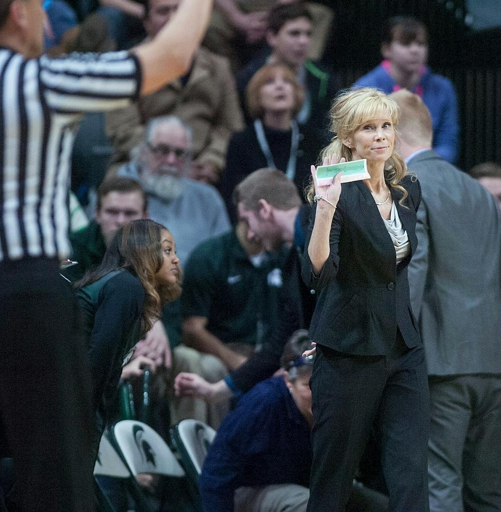 <p>Head coach Suzy Merchant signals to the referee Jan. 18, 2015, during the game against Iowa at Breslin Center. The Spartans were defeated by the Hawkeyes, 52-50. Erin Hampton/The State News</p>