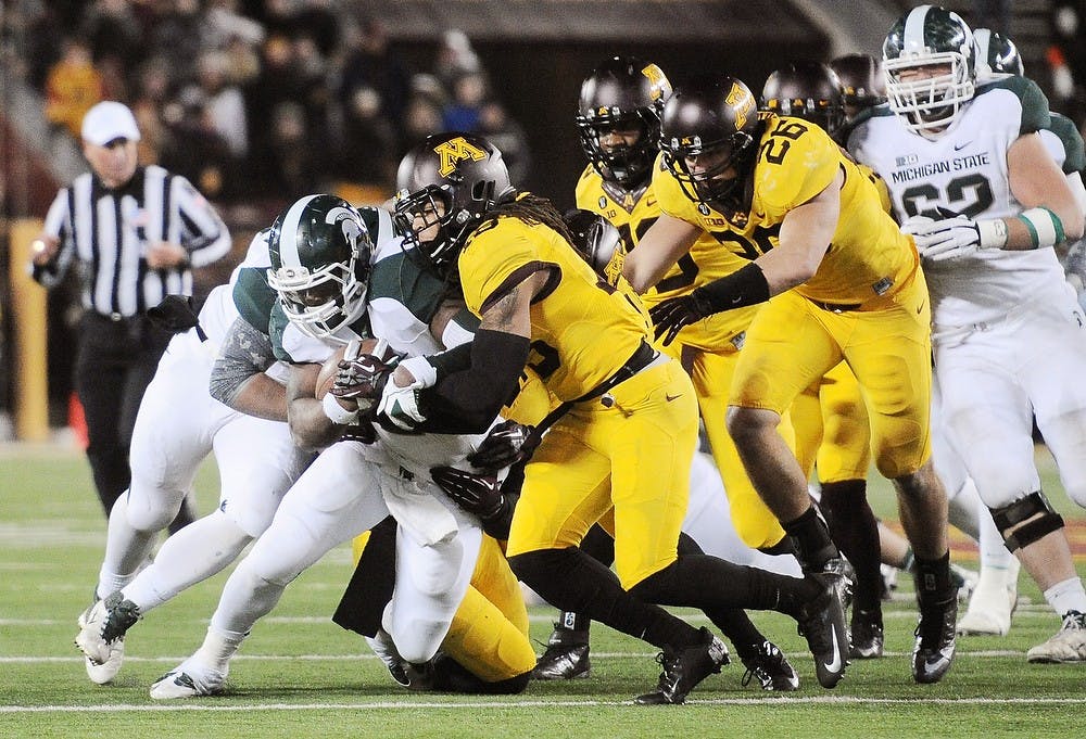 	<p>Junior running back Le&#8217;Veon Bell attempts to break through Minnesota&#8217;s defense Nov. 24, 2012, at <span class="caps">TCF</span> Bank Stadium in Minneapolis. Minn. The Spartans beat Golden Gophers 26-10. Mark Vancleave/The Minnesota Daily</p>