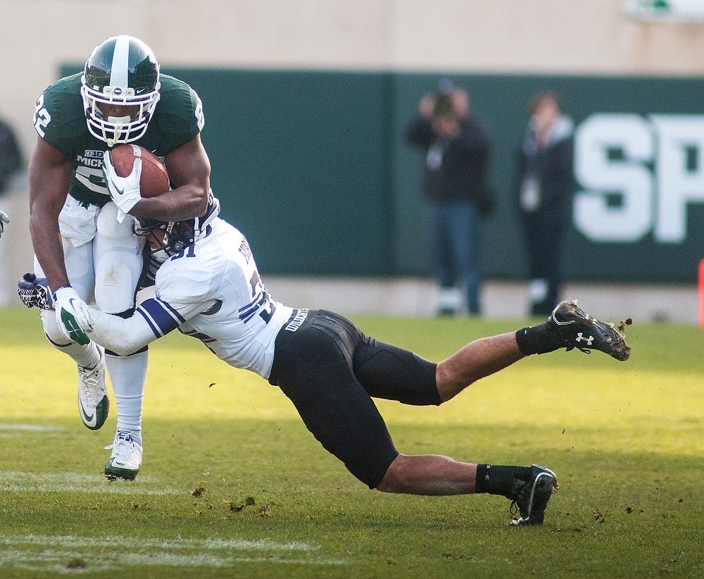 	<p>Senior running back Larry Caper gets tackled by cornerback Quinn Evans on Saturday, Nov. 17, 2012, at Spartan Stadium. The Spartans&#8217; fell to Northwestern 23-20. James Ristau/The State News</p>