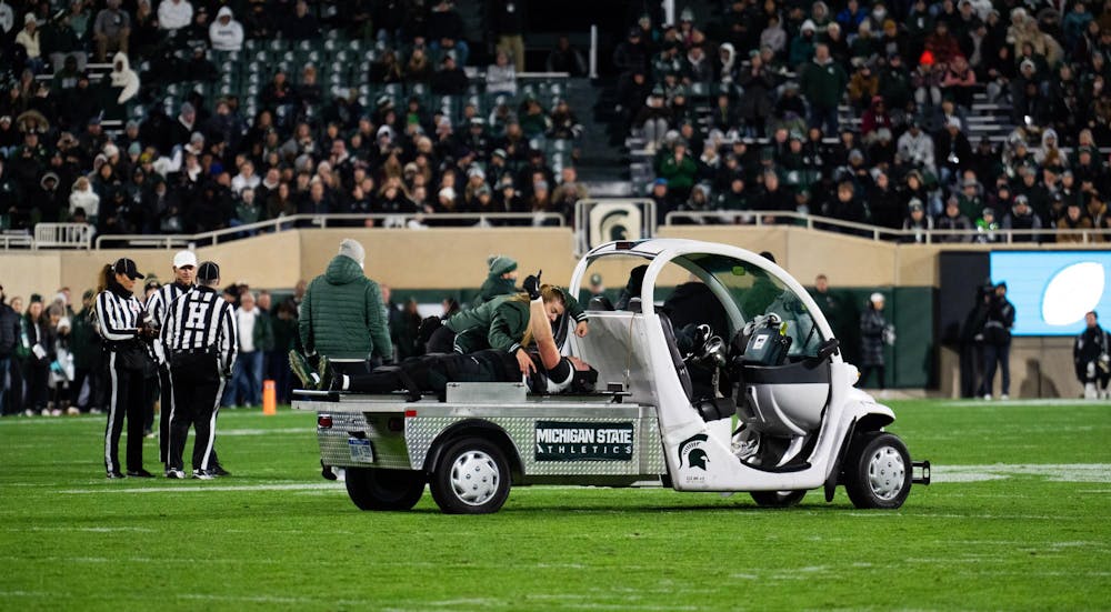 Michigan State football defensive back Justin Denson Jr. (12) gives a thumbs-up after an injury at Spartan Stadium on Nov. 22, 2024.