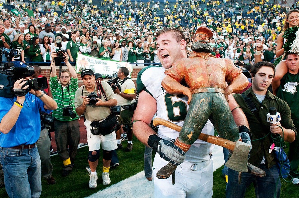 <p>Senior center John Stipek holds the Paul Bunyan Trophy after the Spartans defeated U-M 34-17 on Oct. 9, 2010, at Michigan Stadium in Ann Arbor. Stipek started as a defensive lineman at MSU, but was later moved to the offensive line where he has become the player he is today. State News File Photo</p>