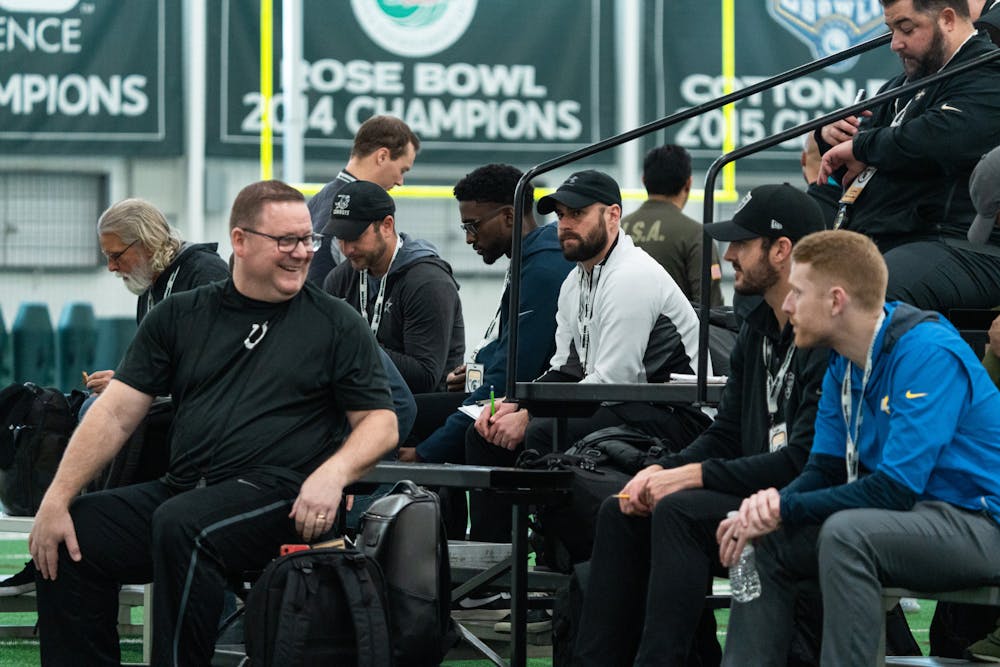 <p>NFL Draft Pro Day recruiters watching the 40 yard dashes, on Mar. 16, 2022 at the Duffy Daugherty Indoor Football Building.</p>
