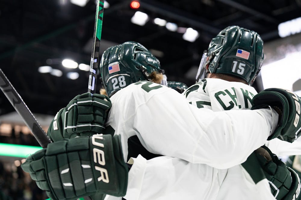 <p>Players celebrate after scoring a goal during a game against the University of Massachusetts at Munn Ice Arena on Oct. 13, 2022. The Spartans defeated the Minutemen with a score of 4-3.&nbsp;</p>