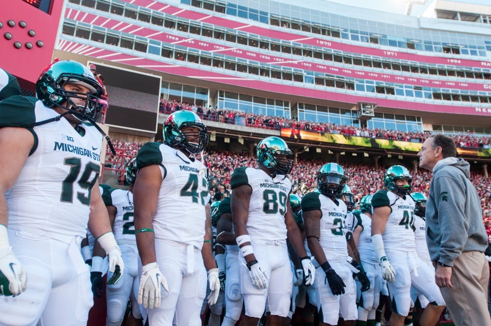 	<p>Head coach Mark Dantonio and his players prepare to head onto the field before the game against Nebraska on Nov. 16, 2013, at Memorial Stadium in Lincoln, Neb. The Spartans defeated the Cornhuskers, 41-28. Khoa Nguyen/The State News</p>