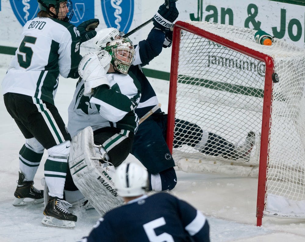 	<p>Sophomore left defender R.J. Boyd and goaltender Will Yanakeff watch the puck just barely miss the net after a shot by Penn State on Friday, Jan. 25, 2013 at Munn Ice Arena. The final score was 5-3 with the Spartans taking the win. Katie Stiefel/The State News</p>