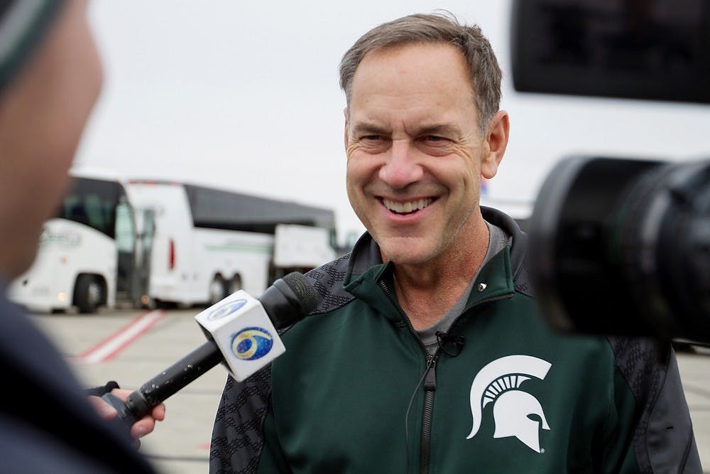 	<p><span class="caps">MSU</span> head coach Mark Dantonio smiles in response to press questions Dec. 8, 2013, at the Capital Region International Airport in Lansing following his team&#8217;s 34-24 victory in the Big Ten Championship Game. Simon Schuster/The State News </p>