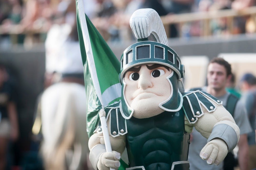 <p>Sparty waves a Michigan State flag on Sept. 4, 2015, during the game against Western Michigan University at Waldo Stadium in Kalamazoo, Mich. The Spartans defeated the Broncos 37-24. Alice Kole/The State News</p>
