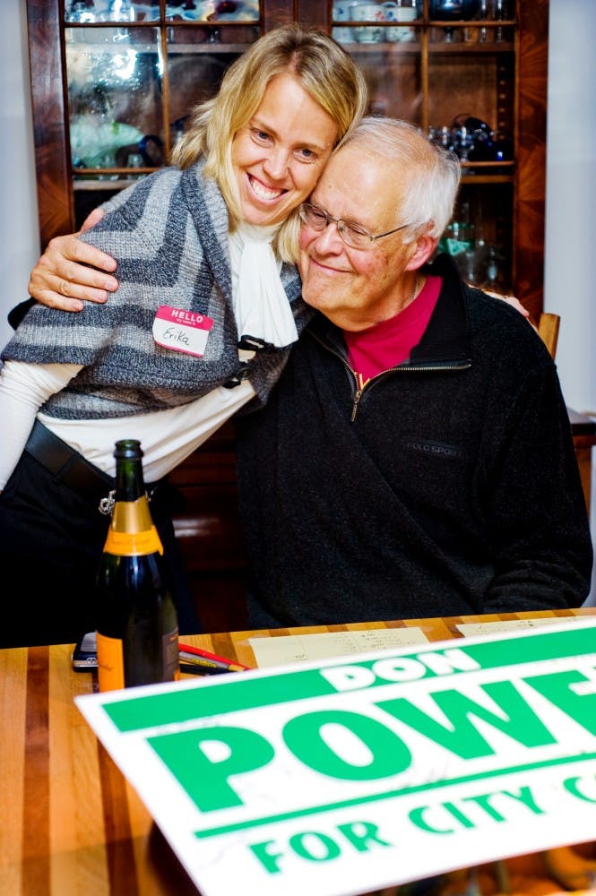 Non-incumbent Don Power hugs his former graduate student Erika Lapish after learning he won the third seat in the East Lansing city council election at his East Lansing home on Tuesday night. Power won the seat with 1643 votes, and the other two seats went to Nathan Triplett and Goddeeris. Lauren Wood/The State News