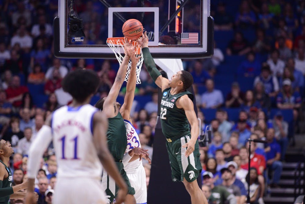 Freshman forward Miles Bridges (22) blocks a shot made by University of Kansas center Landen Lucas (33) during the first half of the game against University of Kansas in the second round of the Men's NCAA Tournament on March 19, 2017 at  at the BOK Center in Tulsa, Okla.The Spartans were defeated by the Jayhawks, 90-70.