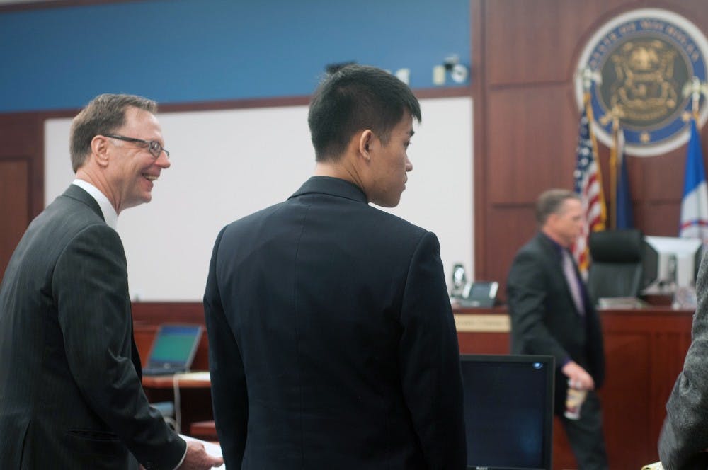 <p>Meng Long Li stands waiting during his retrial May 27 at the Veterans Memorial Courthouse in Lansing. Asha Johnson/The State News</p>