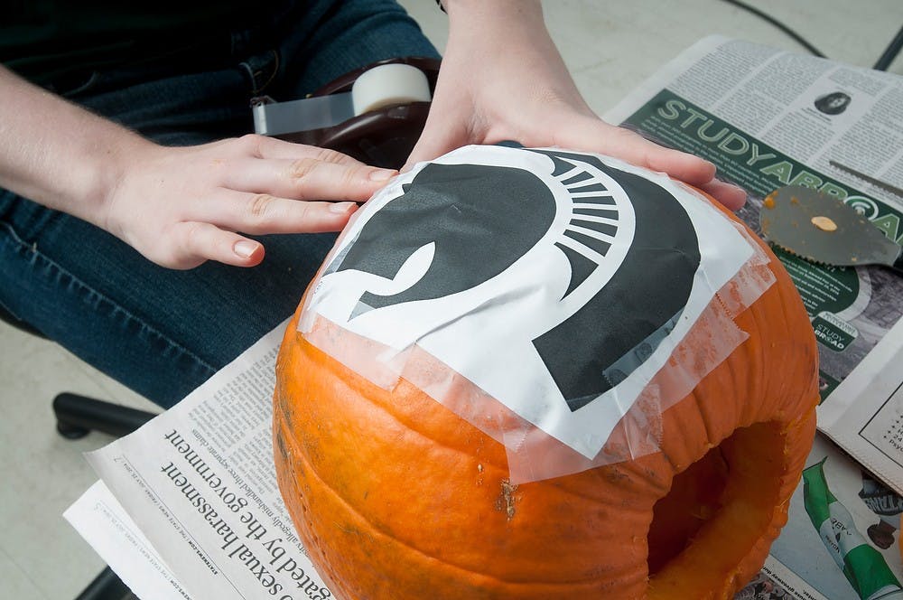 <p>Step 3 tape the design on the pumpkin. Aerika Williams/The State News </p>