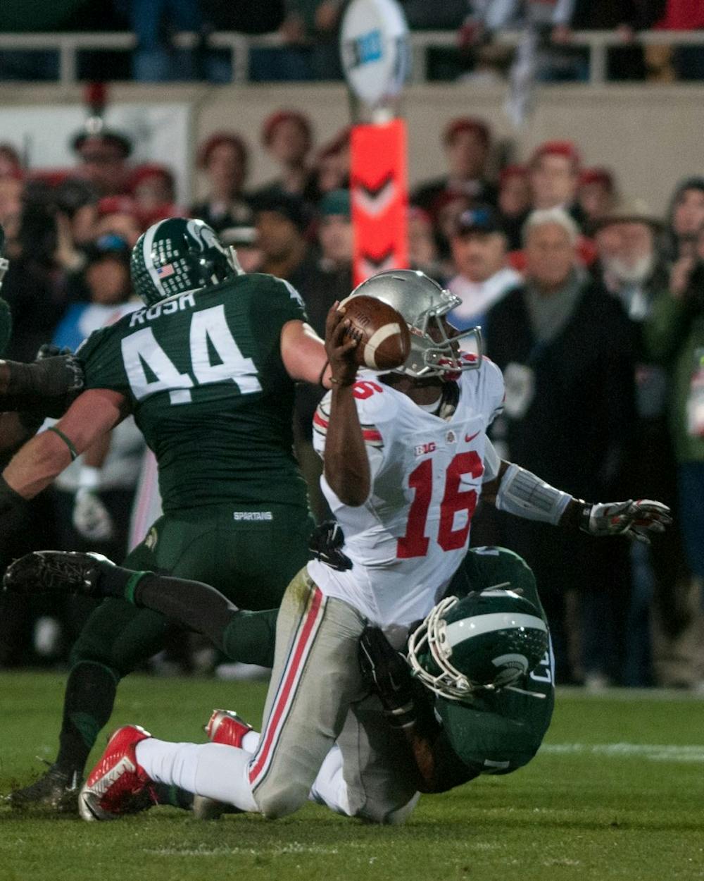 <p>Junior defensive lineman Joel Heath sacks Ohio State quarterback J.T. Barrett during the game against Ohio State on Nov. 8, 2014, at Spartan Stadium. The Spartans were defeated by the Buckeyes, 49-37. Raymond Williams/The State News</p>