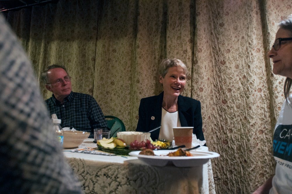 Democratic prosecutor candidate Carol Siemon, center, discusses voting results with guests during an election watch party on Nov. 8, 2016 in Okemos, Mich. 