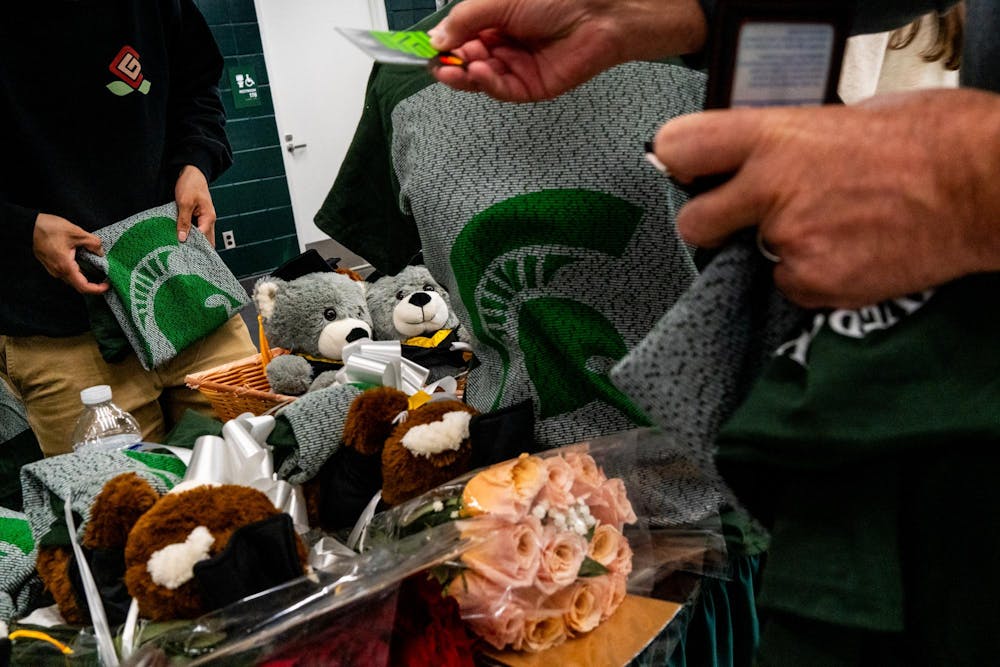 Ellas Pescador, 18, of Illinois, folds a 2026 graduate T-shirt during the Michigan State University College of Communication Arts and Sciences graduation ceremony at the Breslin Student Events Center on Michigan State University’s campus in East Lansing, Mich., on Friday, May 1, 2026.